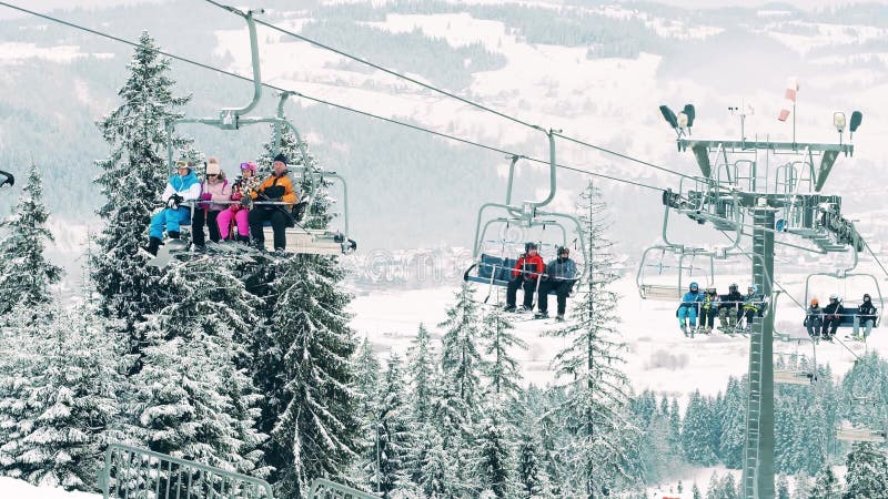 BIALKA TATRZANSKA, POLAND - FEBRUARY 3, 2018. Mountain ski lift or chairlift against beautiful winter scenery on the