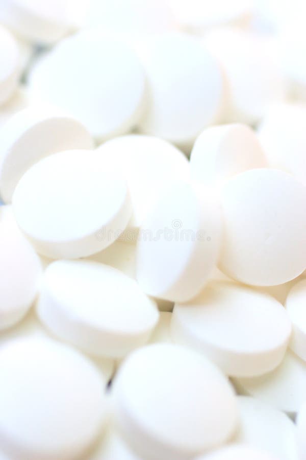 White pills on a white background. White pills on a white background
