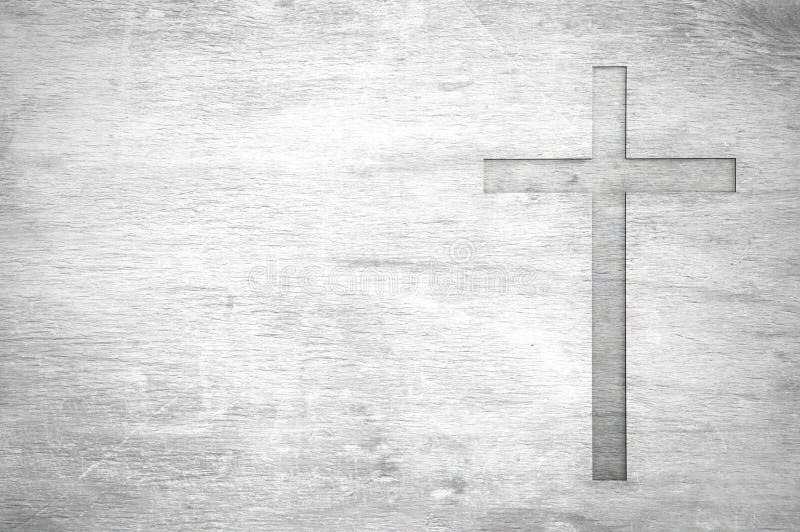 White old christian religion symbol cross shape as sign of belief on a grungy wood textured with copy space. White old christian religion symbol cross shape as sign of belief on a grungy wood textured with copy space.