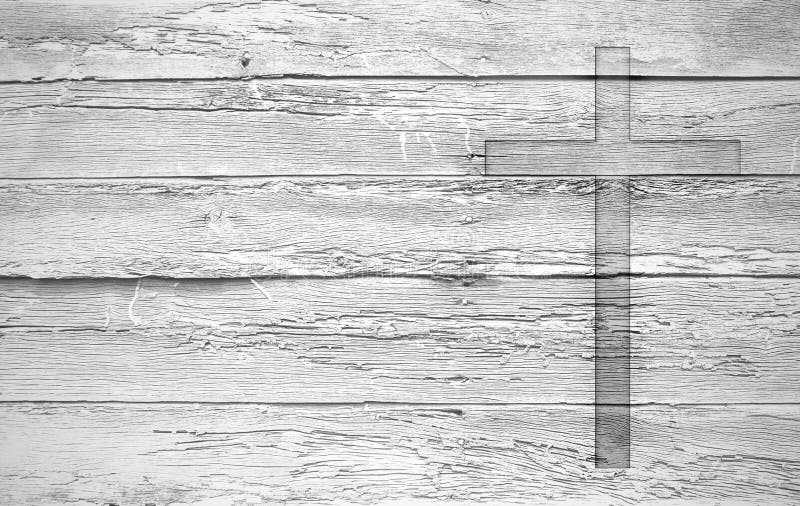 White old christian religion symbol cross shape as sign of belief on a grungy wood textured with copy space. White old christian religion symbol cross shape as sign of belief on a grungy wood textured with copy space.