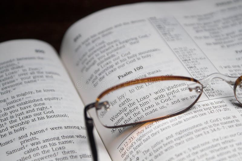 A bible open to scripture and reading glasses. A bible open to scripture and reading glasses