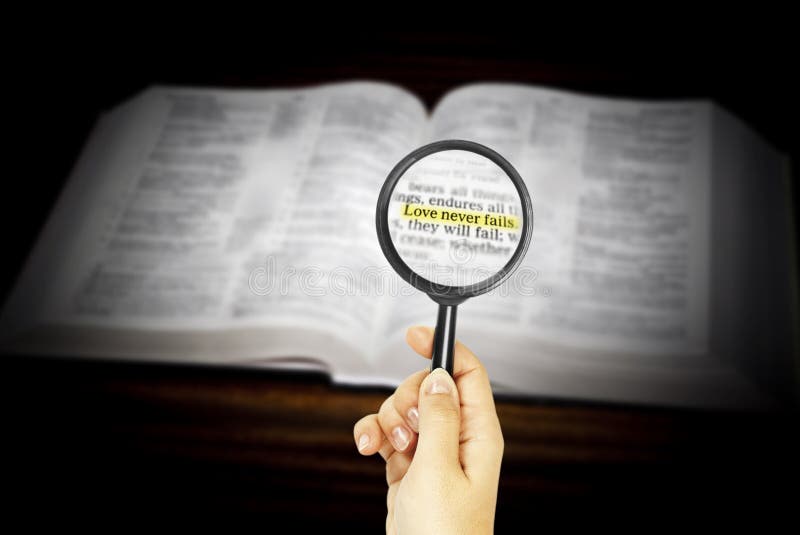 Marked phrase in Holy Bible under magnifying glass