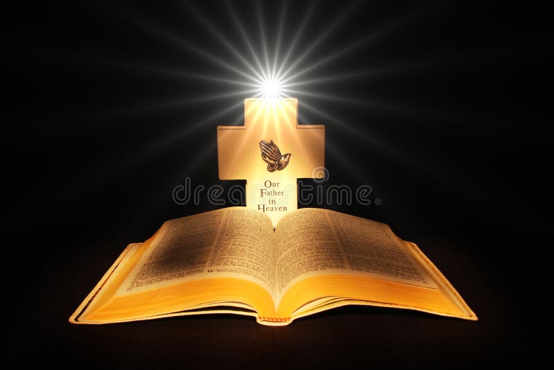 Bible and cross with the light of god.