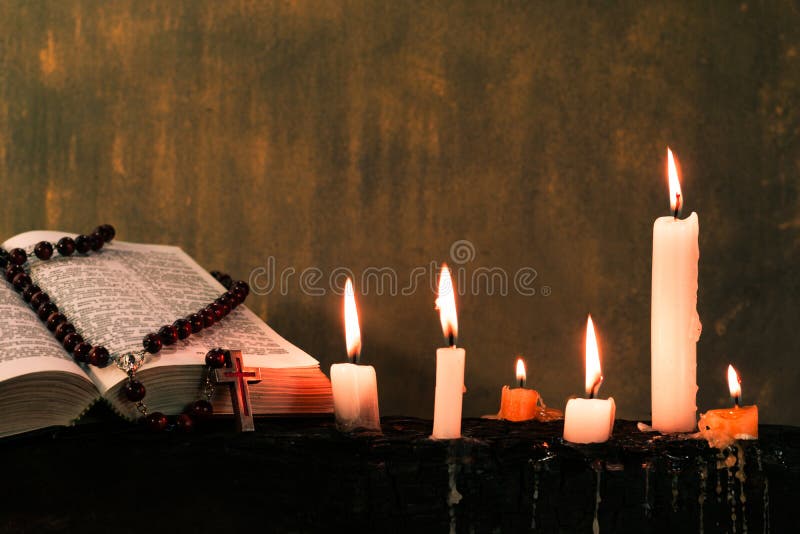 Candles on an old wooden burnt table. Beautiful dark background. Religious concept. stock photos Candles on an old wooden burnt table. Beautiful dark background. Religious concept. stock photos