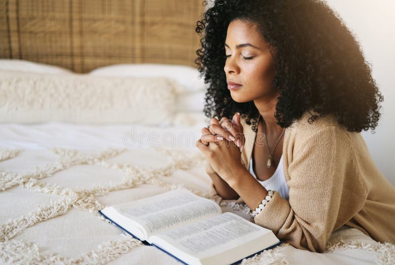 Bible, prayer and black woman praying on bed in bedroom home for hope, help or spiritual faith. God, christian and