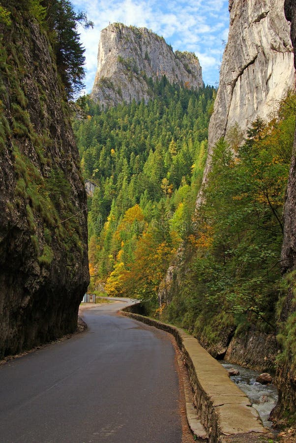 Bicaz gorge in transylvania: cold spring, curved road and vertical rocky walls. Bicaz gorge in transylvania: cold spring, curved road and vertical rocky walls