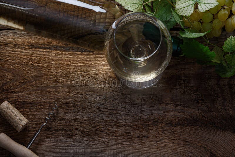 Glass of white wine on vintage wooden table. Top view. Glass of white wine on vintage wooden table. Top view