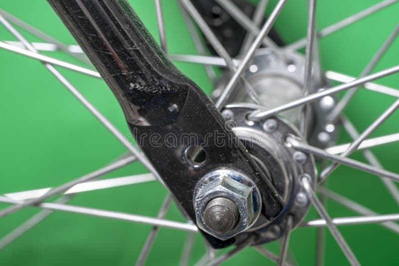 Bicycle Front Wheel Hub with Spokes Fitting Detail on Green Background