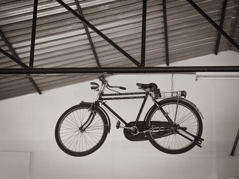 Bicycle Hanging On A Metal Frame Under The Ceiling Of A Building