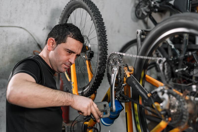 Bicycle Mechanic in a in the Repair Process. Stock Photo