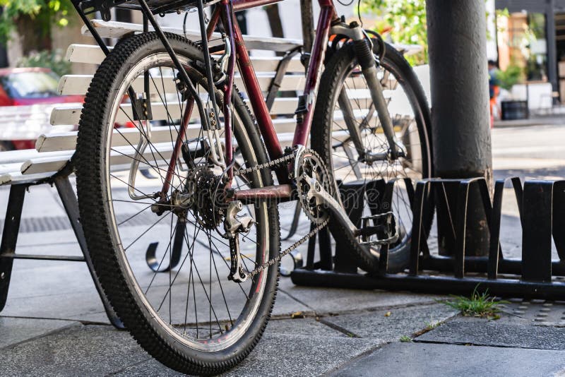 Bicycle Parked in a Bicycle Rack in a Corner of the Sidewalk Stock