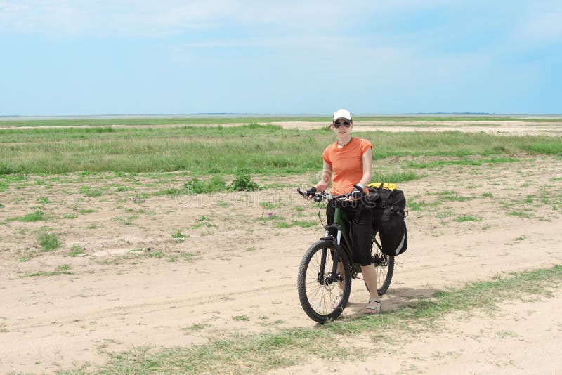 Bicycle tourist girl standing on road