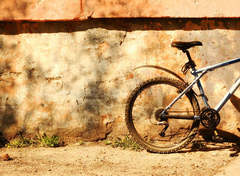 Bicycle at the wall on a sunny day