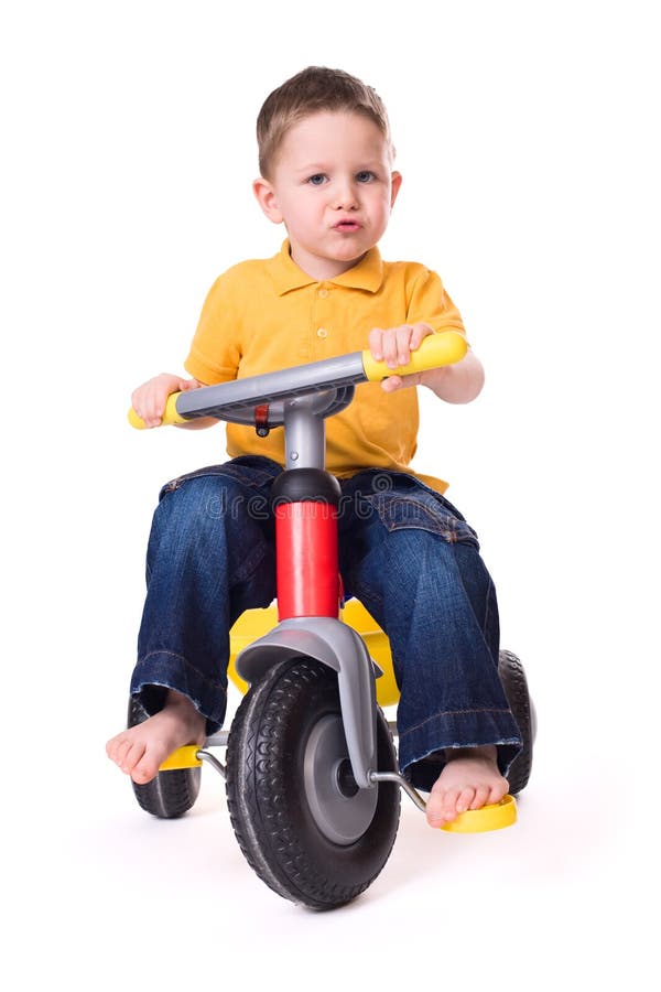 Cute little boy riding a 3-wheel bike. Isolated on white background. Cute little boy riding a 3-wheel bike. Isolated on white background