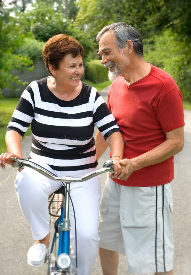 An attractive senior couple bicycling