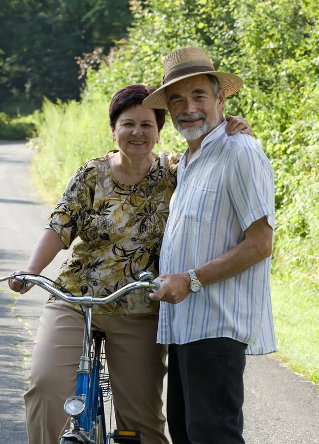 An attractive senior couple bicycling. An attractive senior couple bicycling