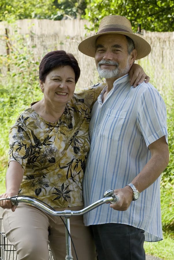 An attractive senior couple bicycling. An attractive senior couple bicycling