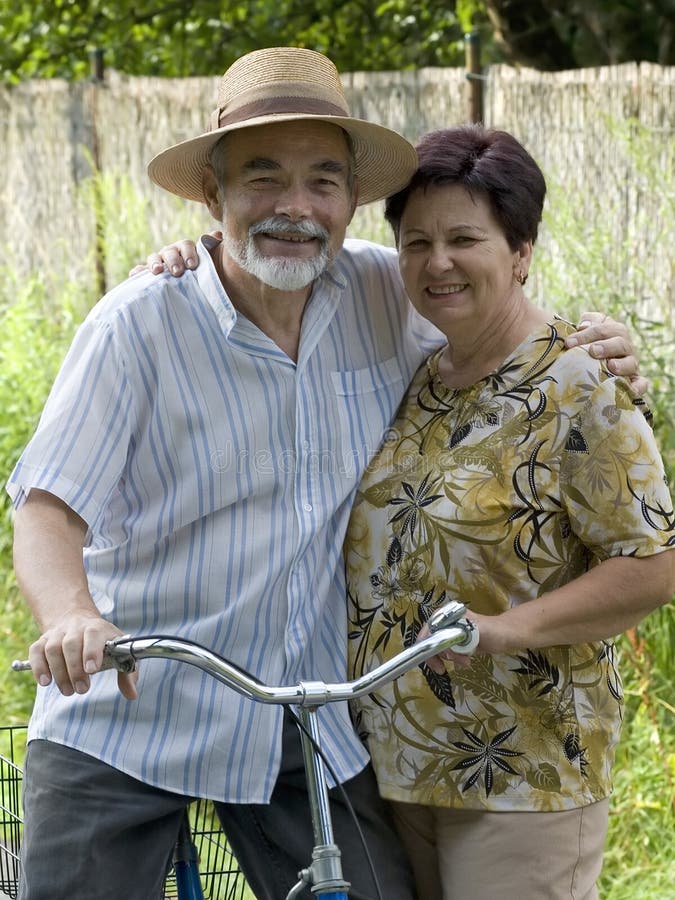 An attractive senior couple bicycling. An attractive senior couple bicycling