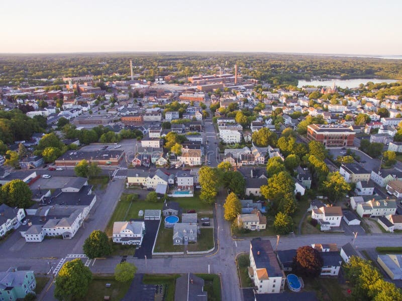 Houses in the small town of Biddeford in Maine, with an old factory in the background. Houses in the small town of Biddeford in Maine, with an old factory in the background.