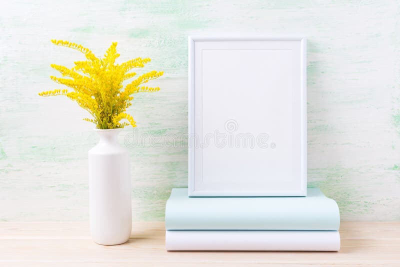 White frame mockup with wild ornamental golden yellow grass and books. Empty frame mock up for presentation design. Template framing for modern art. White frame mockup with wild ornamental golden yellow grass and books. Empty frame mock up for presentation design. Template framing for modern art.