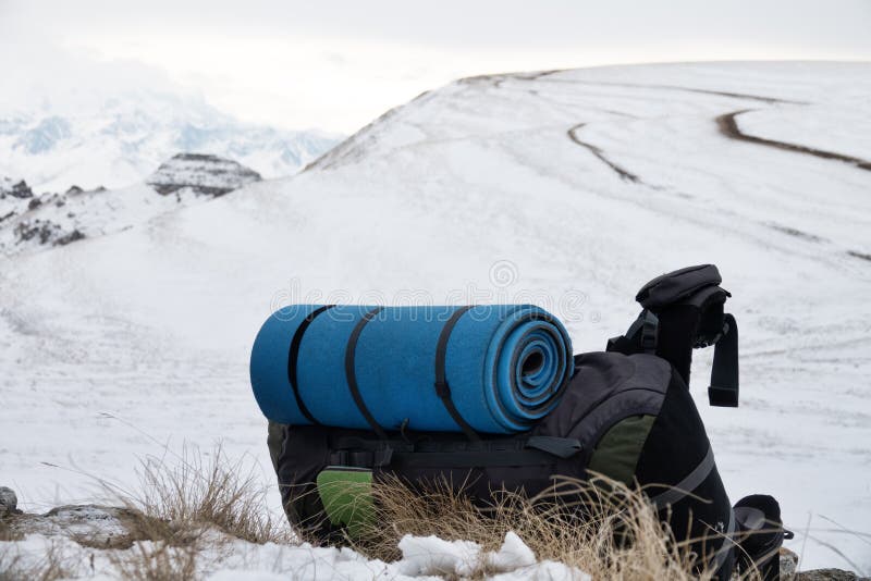 Big backpack in winter in mountains on a halt stock images