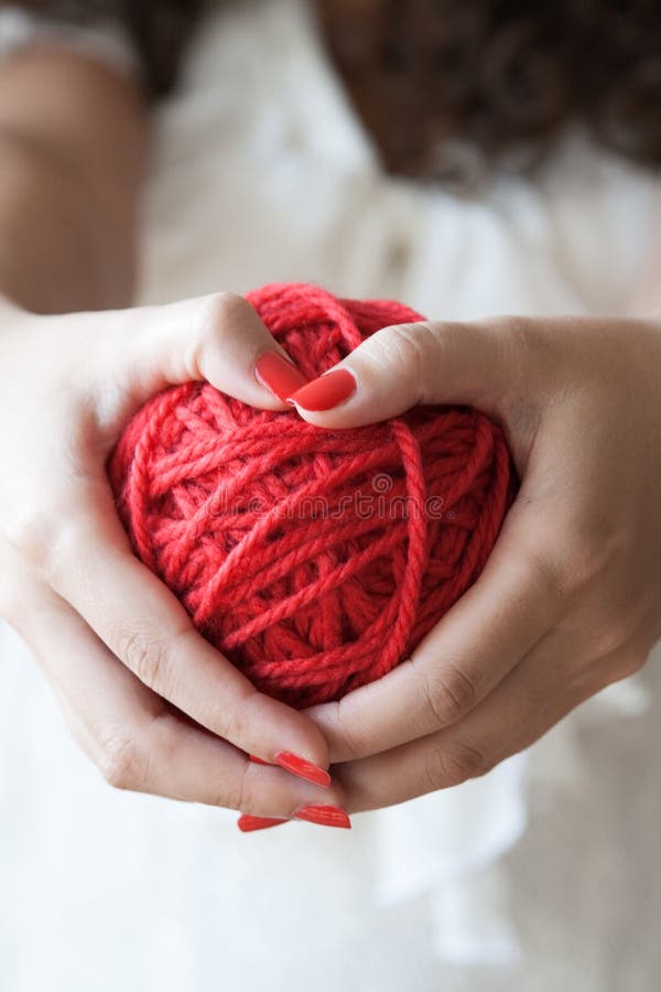 Big ball of red wool in the hands