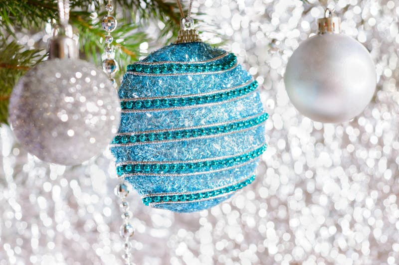 Big beautiful blue ball, green branch of spruce on a light blurred background royalty free stock images Big beautiful blue ball, green branch of spruce on a light blurred background royalty free stock images