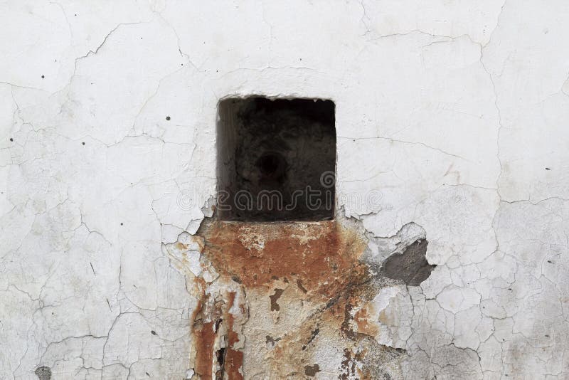 Big Black Square Hole at the Old White Stony Wall with a Rust Stock
