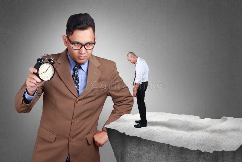 Time Discipline Concept. Big Boss with serious face caught latecomer. Businessman holds clock in hand angry to employee for being late. Time discipline concept royalty free stock photo Time Discipline Concept. Big Boss with serious face caught latecomer. Businessman holds clock in hand angry to employee for being late. Time discipline concept royalty free stock photo