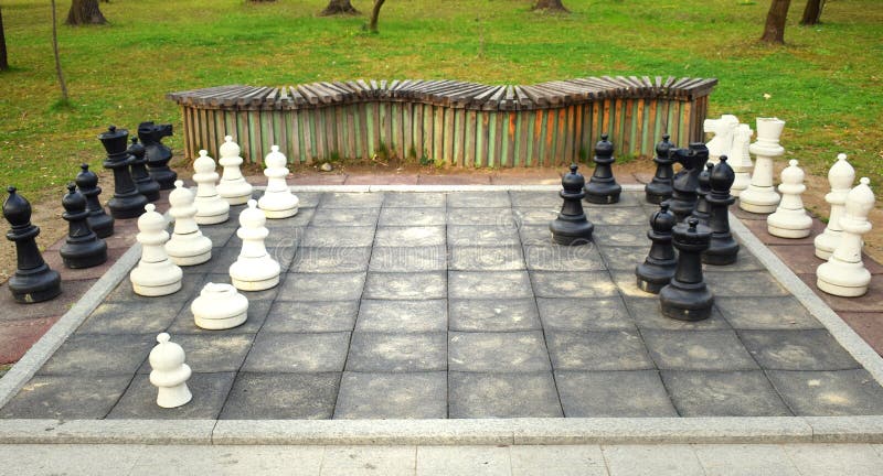 Big chess board with huge pieces in the park royalty free stock images Big chess board with huge pieces in the park royalty free stock images