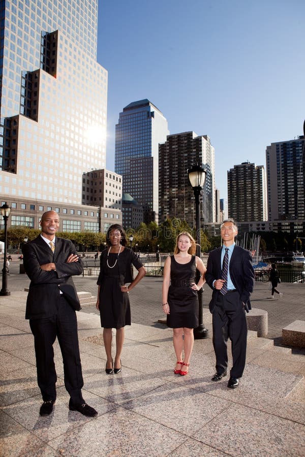 A business team portrait with large buildings in the background. A business team portrait with large buildings in the background