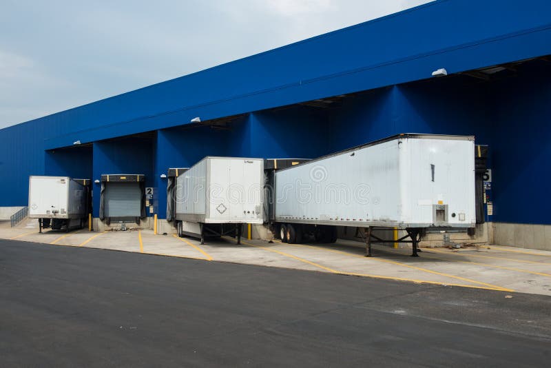 Big distribution warehouse with gates for loads and trucks