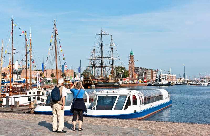 Sail Bremerhaven with traditional sailing ships and people from behind to the harbour tour, Germany. The big event Sail in Bremerhaven with sailing ships, ships stock photography Sail Bremerhaven with traditional sailing ships and people from behind to the harbour tour, Germany. The big event Sail in Bremerhaven with sailing ships, ships stock photography