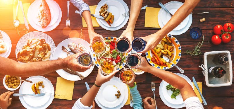 Big family dinner. Vertical top view on served table and hands w