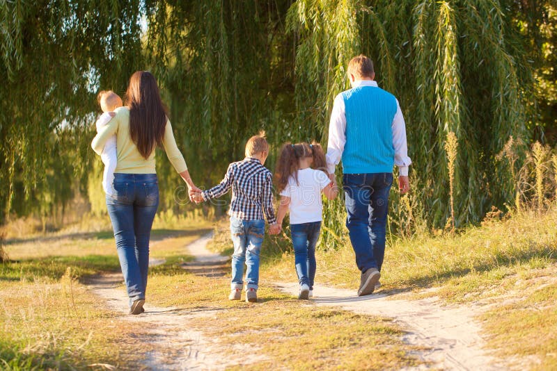 Big family walking in city park.