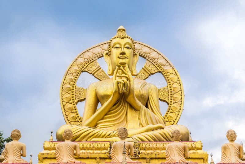 Big golden buddha statue with wheel of dhamma