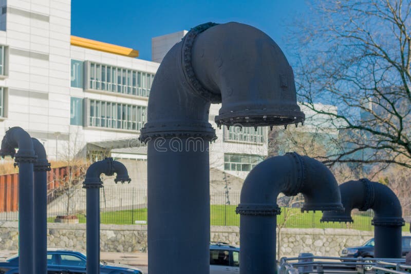 Big Grey Industrial Pipes, Sticking Out of the Ground Stock Photo