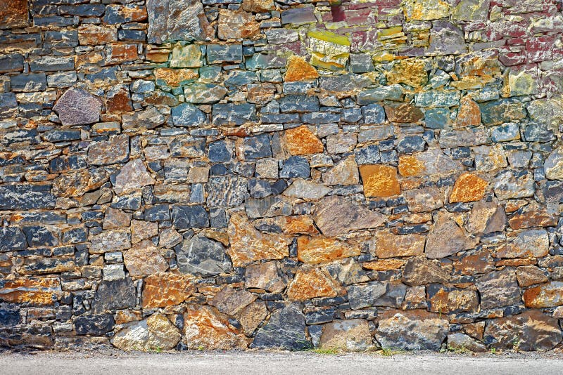 Big grunge colorful stone blocks wall. stock image