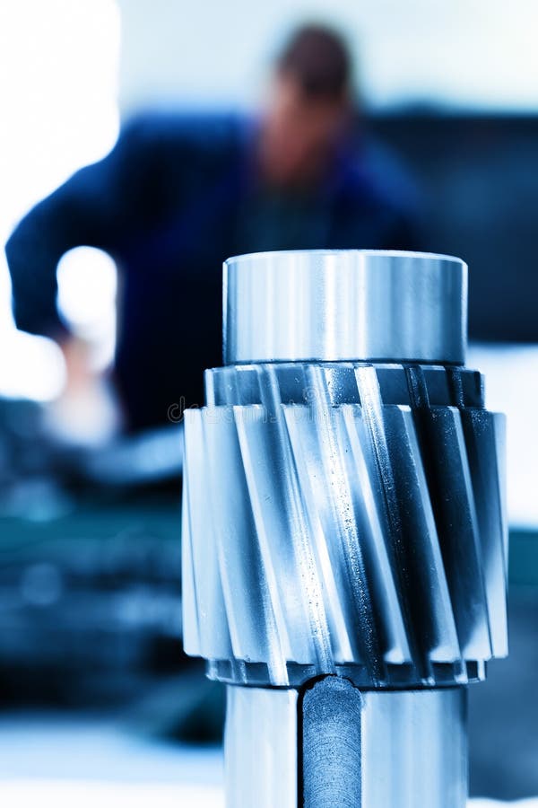 Big industrial element, screw. Man working on machine.