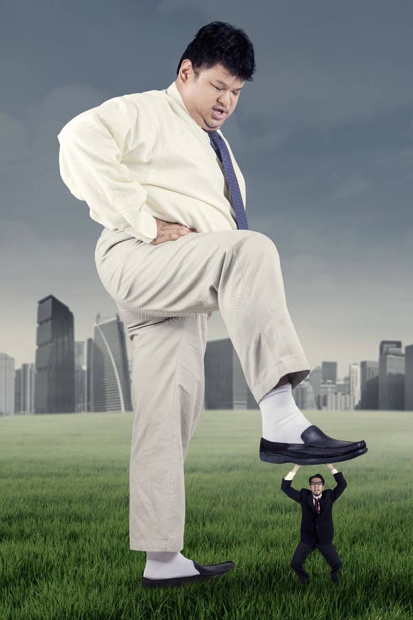 Big male worker treading an employee stock image Big male worker treading an employee stock image