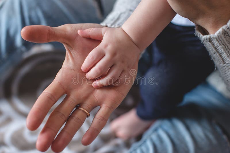 Big man`s and small children`s palms one on another. Father`s love and protection. Succession of generations royalty free stock photo Big man`s and small children`s palms one on another. Father`s love and protection. Succession of generations royalty free stock photo