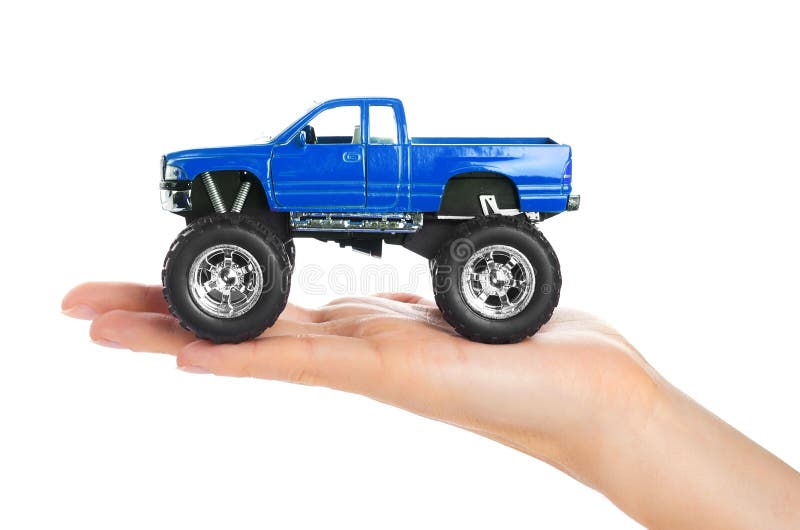 Big metal red toy car offroad with monster wheels in hand isolated on white background royalty free stock photo Big metal red toy car offroad with monster wheels in hand isolated on white background royalty free stock photo