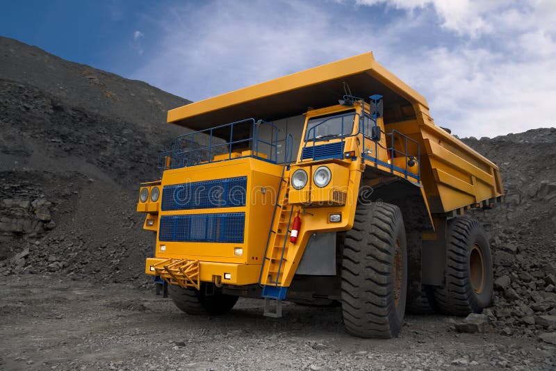 A picture of a big yellow mining truck at worksite. A picture of a big yellow mining truck at worksite