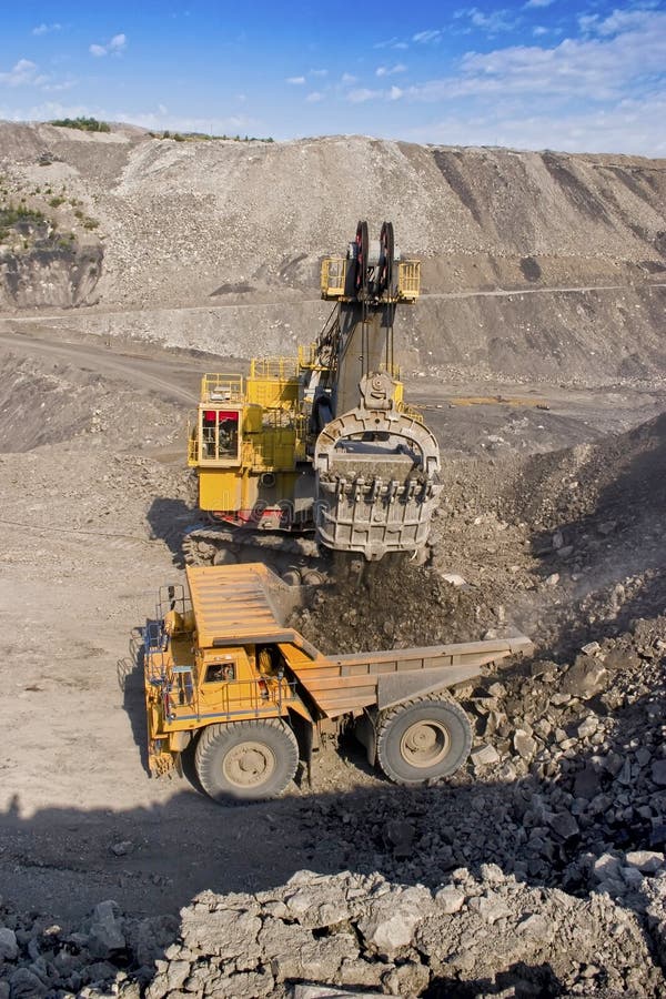 A picture of a big yellow mining truck at worksite. A picture of a big yellow mining truck at worksite