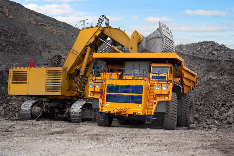 A picture of a big yellow mining truck at worksite. A picture of a big yellow mining truck at worksite