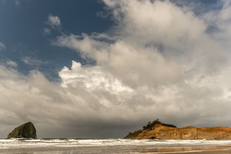 A big mossy rock formation in the sea seen from the Oregon coast in Siletz Bay, OR, US