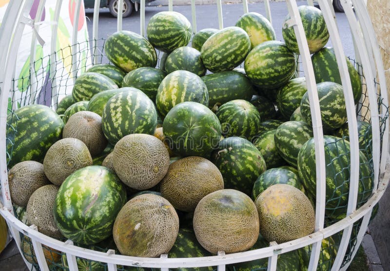 Two Melons on a Purple Background. Seeds Inside the Fruit. Yellow
