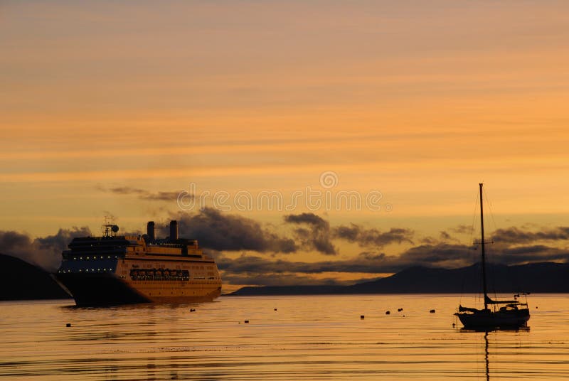 Big passenger ship and yacht at sunrise. royalty free stock photos