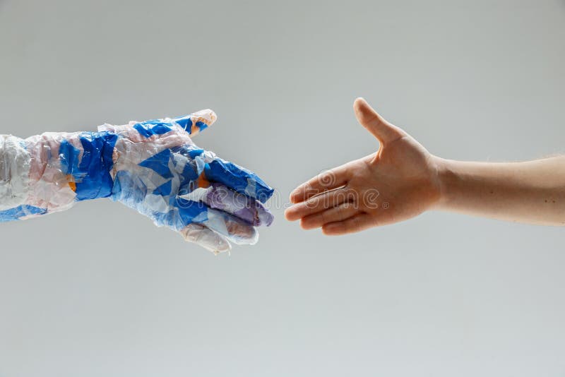 Big Plastic Hand Made Of Garbage Shaking Another Hand Isolated On White