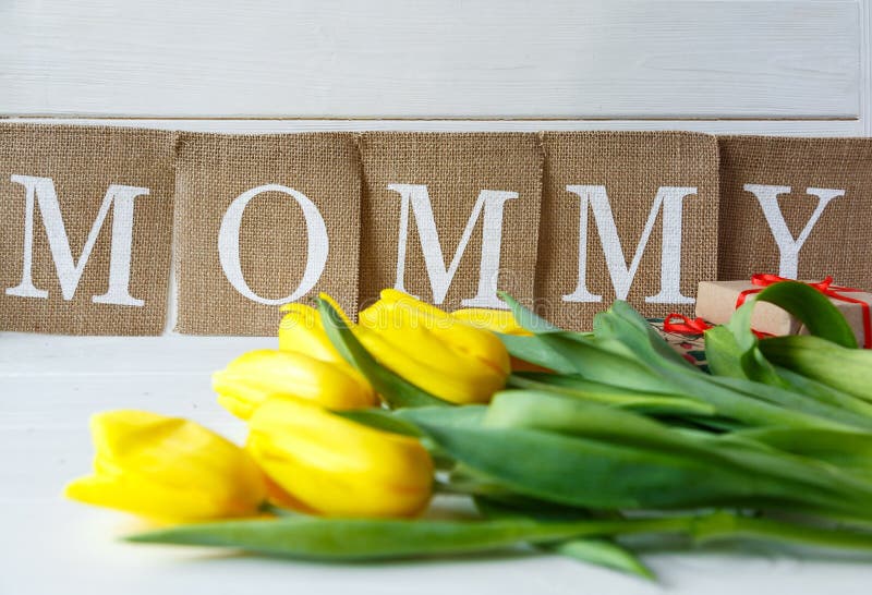 Big red letters Mum lies on the table with gift card and flowers. Mother`s day concept. stock photos Big red letters Mum lies on the table with gift card and flowers. Mother`s day concept. stock photos
